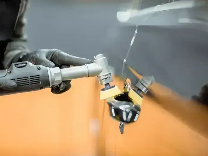 auto glass technician replacing cracked windshield near Shoreline Community College parking area