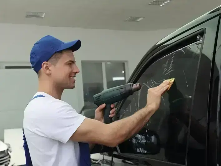 Protech Auto Glass tech inspecting side glass and windshield repair damage on an Eastside SUV