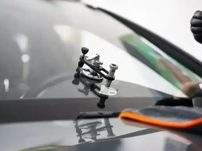 auto glass technician fixing rock chip damage near Log Boom Park in Kenmore WA